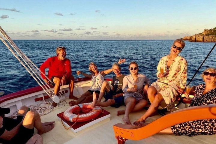 a group of people on a boat in the water