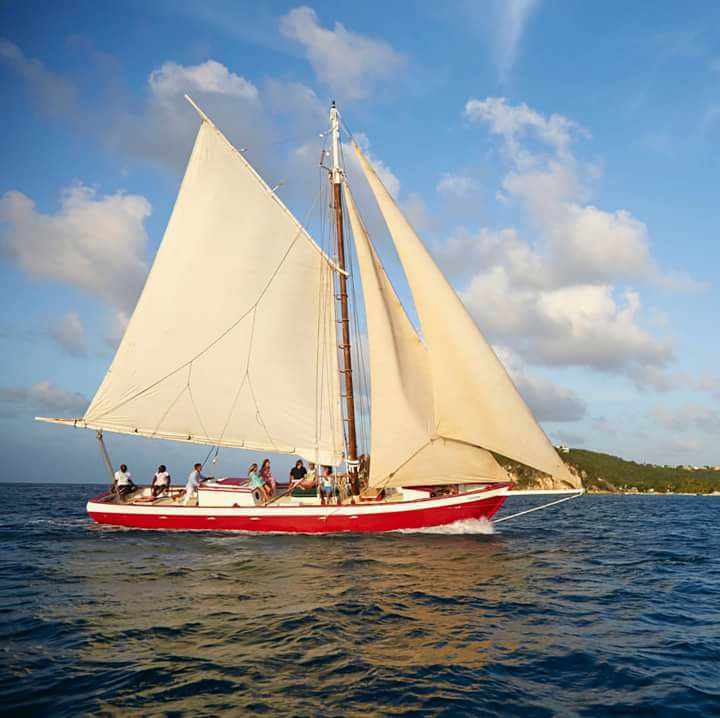 Tradition Sailing historic Caribbean sloop sailing near Anguilla on a clear turquoise day