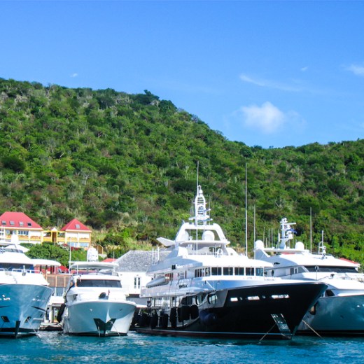a blue and white boat parked next to a body of water