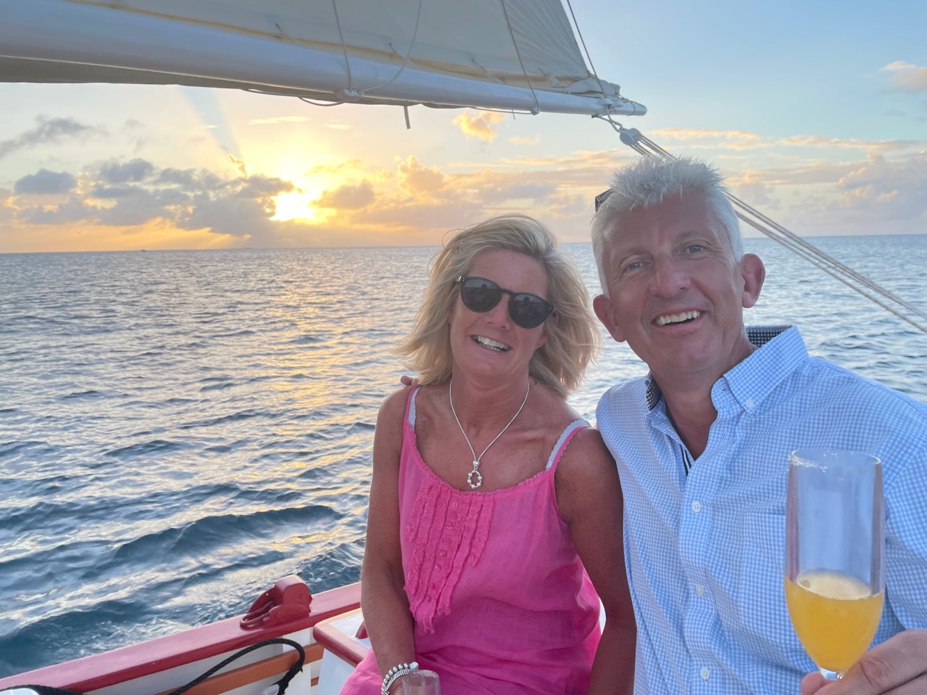 Returning guests enjoying a Sunset sailing experience aboard Tradition, a classic wooden sloop in Anguilla.